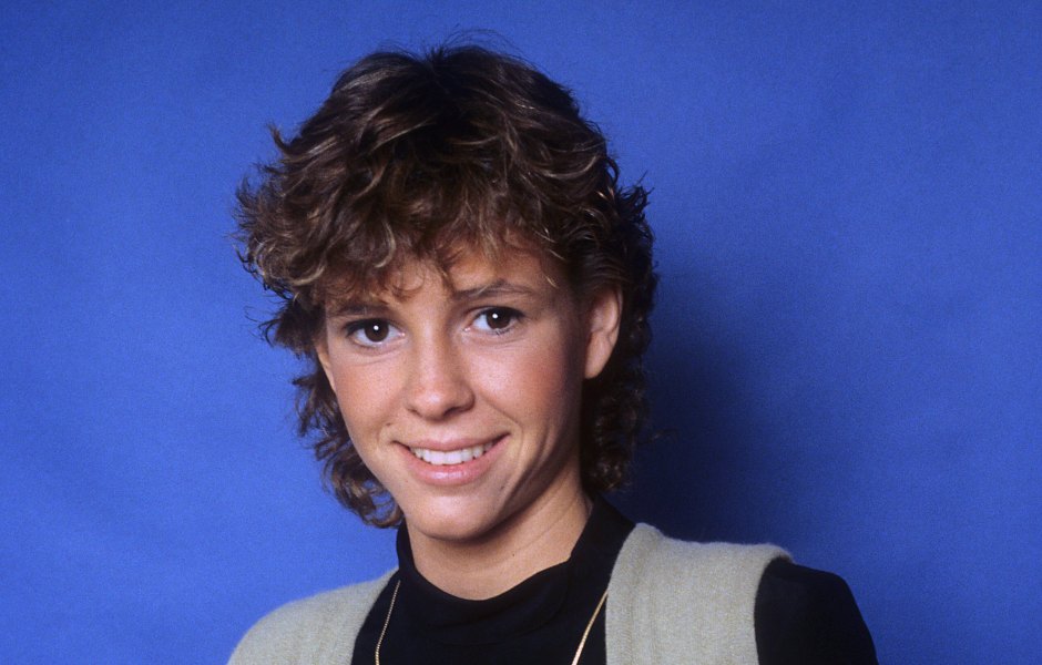 Kristy McNichol wears black long-sleeve shirt and black pants and vest