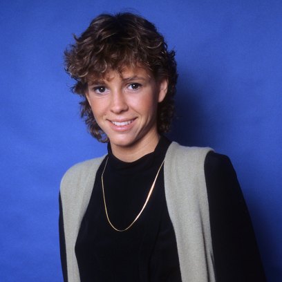 Kristy McNichol wears black long-sleeve shirt and black pants and vest