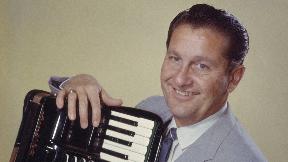 Lawrence Welk (1903-1992), US musician and band leader, smiling while posing with an accordian, circa 1955