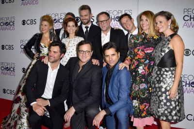 Actress Jodie Sweetin, producer Jeff Franklin, actors Candace Cameron Bure, John Brotherton, Dave Coulier, Scott Weinger, Lori Loughlin, Andrea Barber and (front L-R) actors Juan Pablo Di Pace, Bob Saget and John Stamos, winners of the Favorite Premium Comedy Series Award, 'Fuller House' pose in the press room during the People's Choice Awards 2017