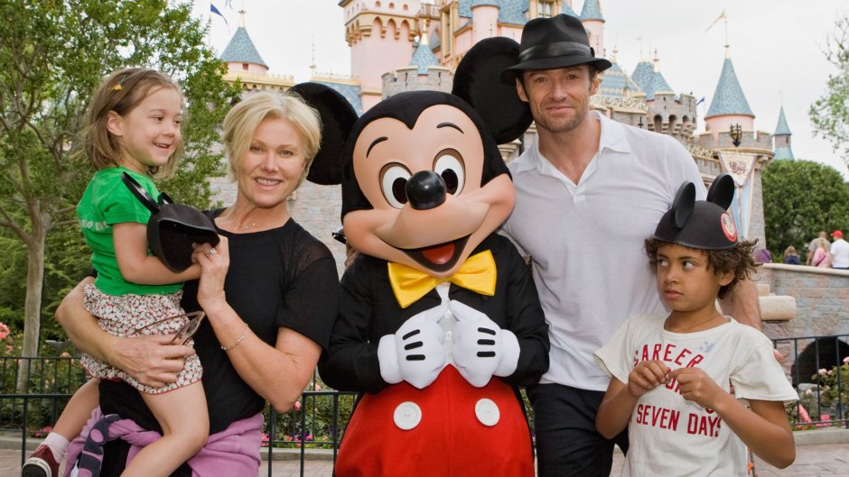 Actor Hugh Jackman, his wife Deborra Lee Furness, and children Oscar Jackman and Ava Jackman pose with Mickey Mouse outside Sleeping Beauty Castle at Disneyland