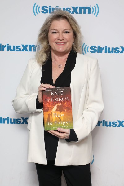Kate Mulgrew holding the book 'How to Forget'