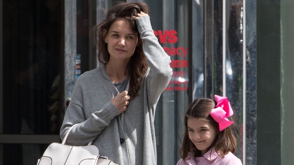 Suri Cruise wearing a Jackie Kennedy-style pink coat with Katie Holmes in New York.