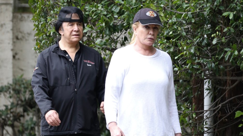 KISS frontman Gene Simmons is seen dressed in a backwards cap, black sweatpants and a matching top as walks his two dogs, George and Baby, with his wife, former Playboy playmate of the year, Shannon Tweed.