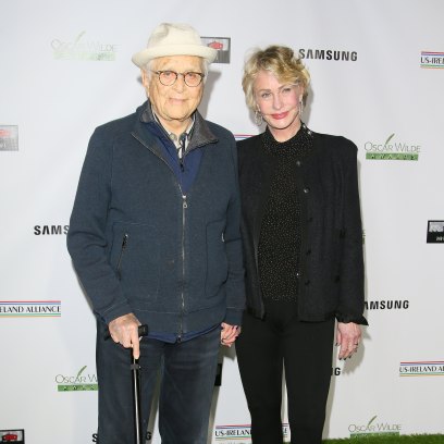 Norman Lear walks with cane in red carpet appearance with wife