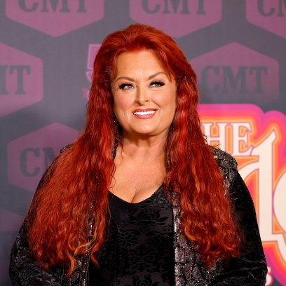 Wynonna Judd smiles while wearing a black outfit