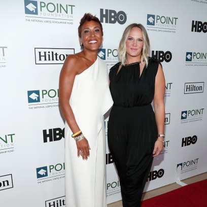 Robin Roberts wears white gown on red carpet next to partner Amber Laign