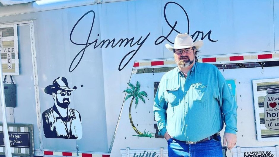 Jimmy Don Holmes poses in front of a trailer
