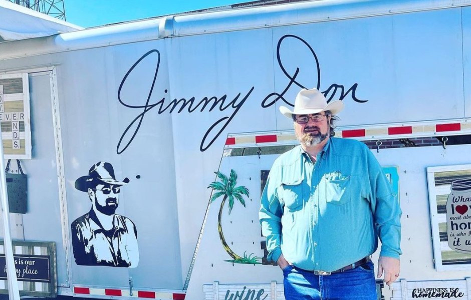 Jimmy Don Holmes poses in front of a trailer