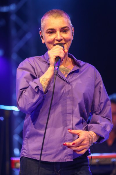 Sinead O'Connor performs in purple shirt