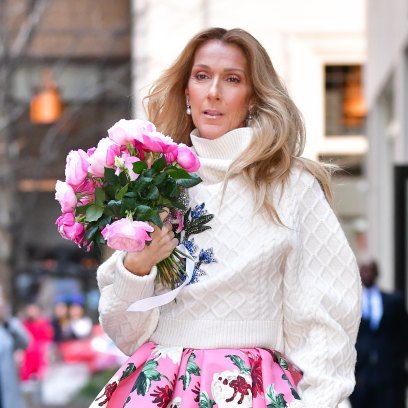 Celine Dion holds bouquet of flowers in floral-printed dress
