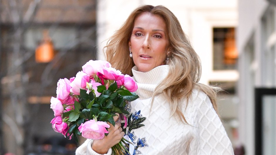 Celine Dion holds bouquet of flowers in floral-printed dress