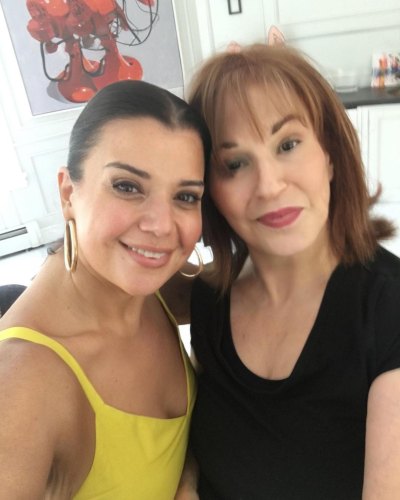 Ana Navarro wears yellow top while posing with Joy Behar