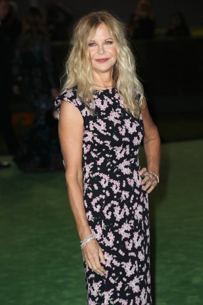Meg Ryan wears floral black and white dress and loose curls in her hair 