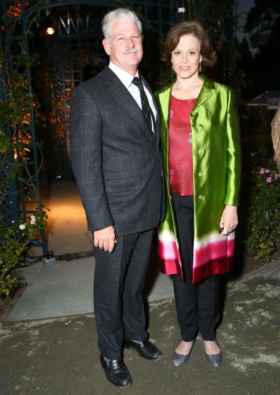 Sigourney Weaver wears green blazer next to suit-clad husband Jim Simpson