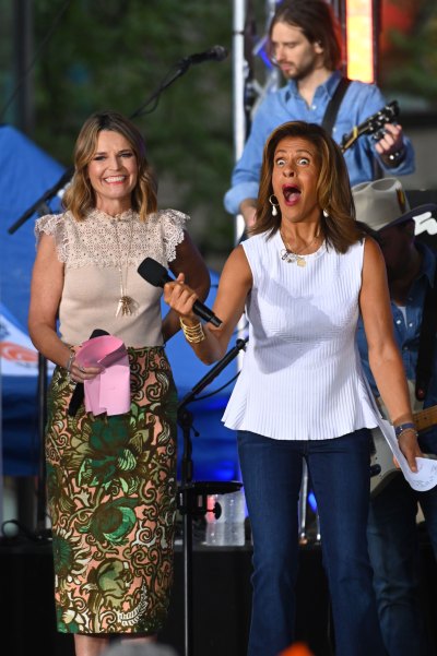 Hoda Kotb and Savannah Guthrie hold microphones on 'Today' show