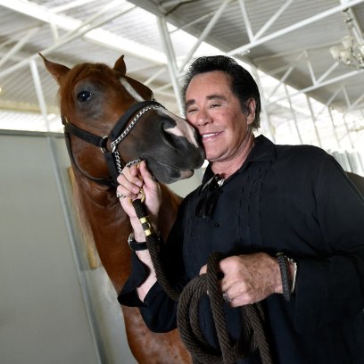 Wayne Newton inside of horse stable at former home