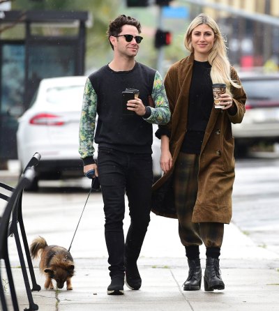 Sasha Farber and Emma Slater hold coffee cups while walking dog 