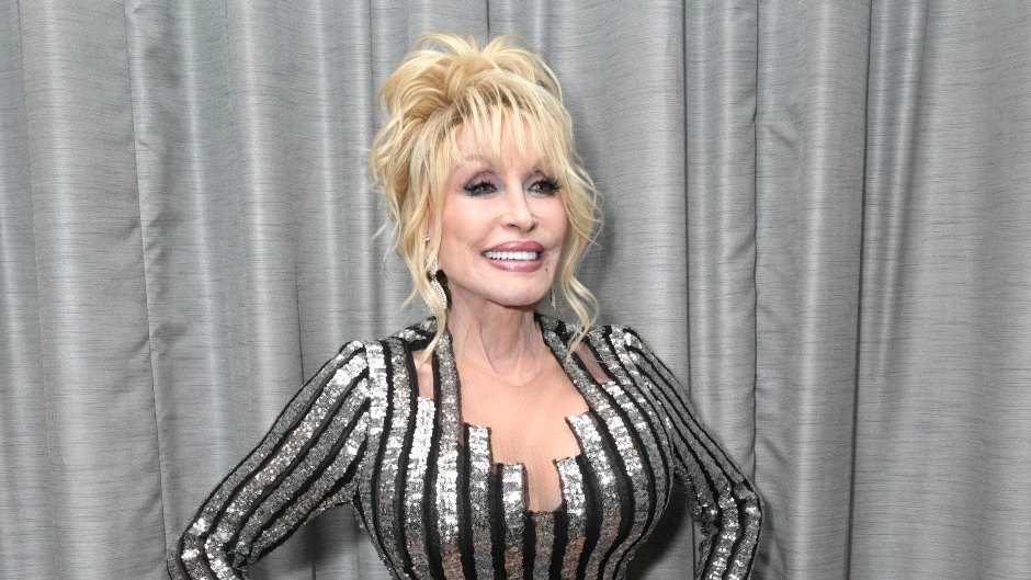 Dolly Parton wears silver and black striped dress with heels