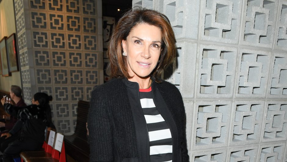 Hilary Farr wears black coat and striped top