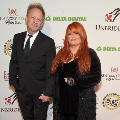 Wynonna Judd holds hands with Cactus Moser