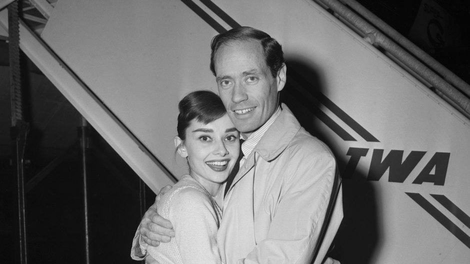 Audrey Hepburn smiles while hugging husband Mel Ferrer