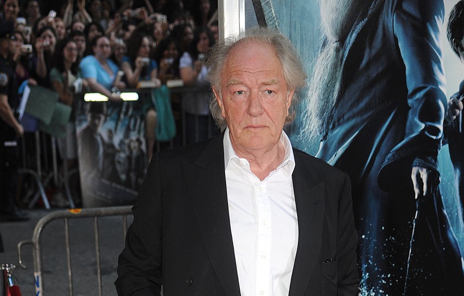 Michael Gambon wears black suit with white shirt underneath