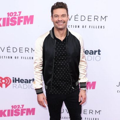 Ryan Seacrest wears black and white bomber jacket with black pants