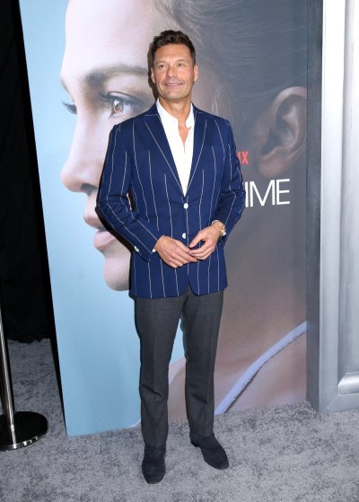 Ryan Seacrest wears blue blazer and gray pants with white button-down shirt