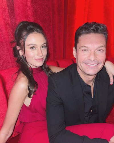 Ryan Seacrest sits next to girlfriend Aubrey Paige Petcosky in red