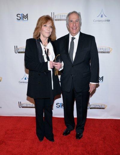 Henry Winkler and wife Stacey Weitzman wear black suits on red carpet
