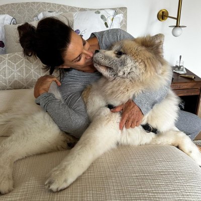 Hilary Farr cuddles up with dog inside of bedroom of North Carolina home