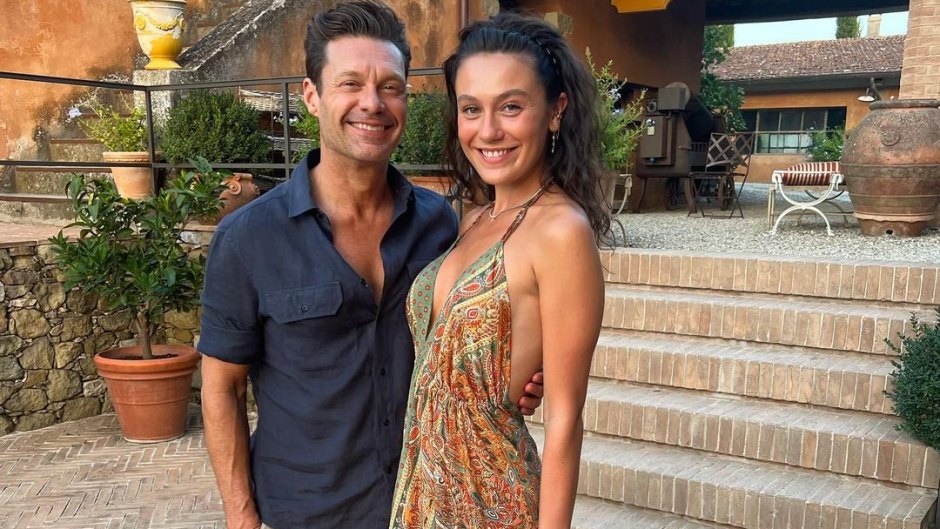 Ryan Seacrest weaars blue shirt and khaki pants in Italy with Aubrey Paige Petcosky