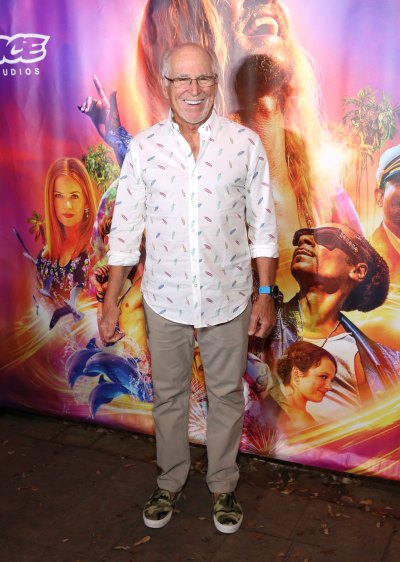 Jimmy Buffett wears button-down shirt and glasses during red caret appearance