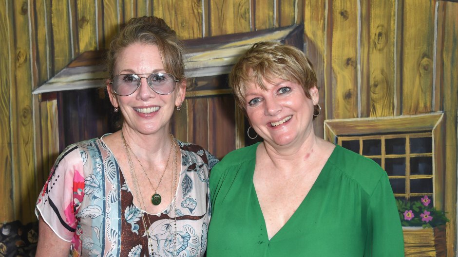 Melissa Gilbert wears sunglasses and patterned top while hugging Alison Arngrim