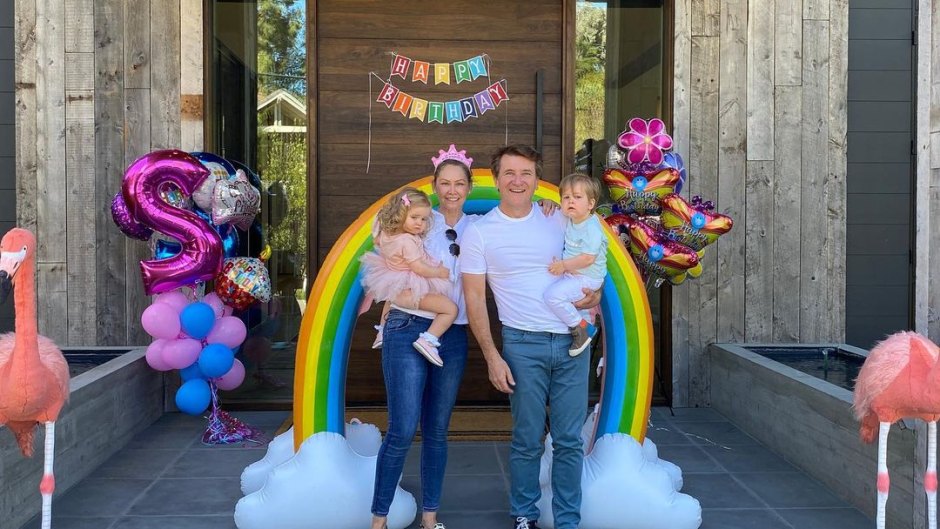 Kym Johnson and Robert Herjavec stand outside of former home with kids