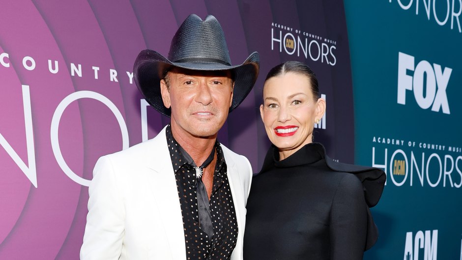 Tim McGraw wears white suit with black shirt and Faith Hill wears black drss with black boots