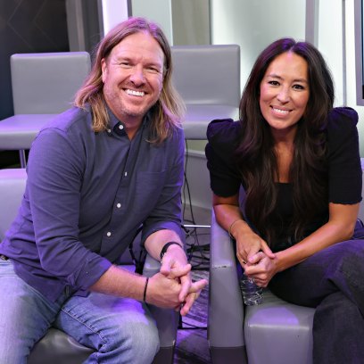 Chip and Joanna Gaines sit side by side on gray couches