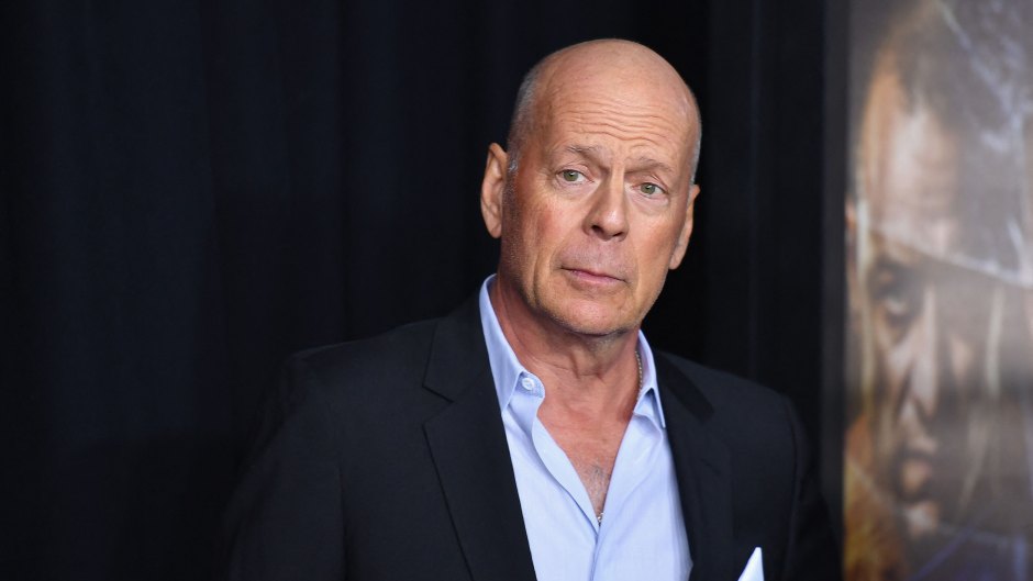 Bruce Willis wears black suit with white button-down shirt