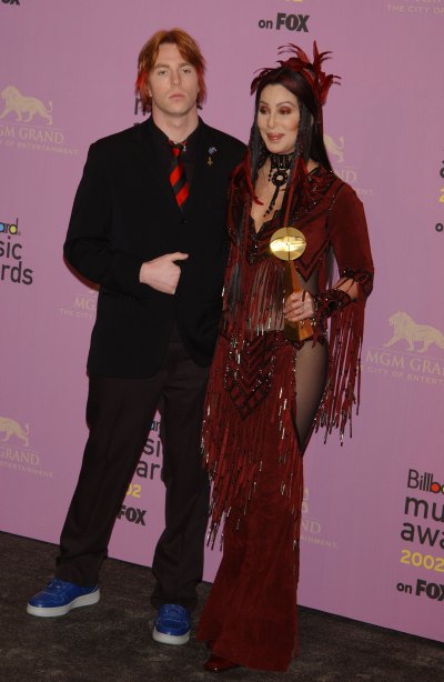 Cher wears feathered outfit with son Elijah