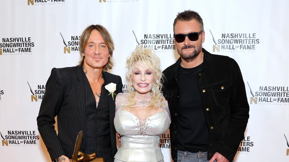 Keith Urban stands with Dolly Parton and Eric Church