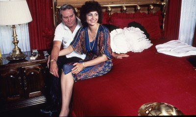 George Jones and Nancy Jones sit on bed in their home