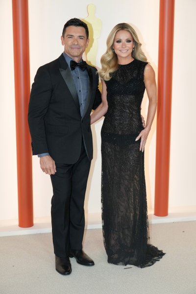 Kelly Ripa wears black see-through dress with hair in loose curls during red carpet appearance with Mark Consuelos