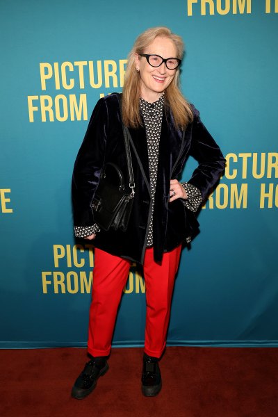 Meryl Streep wears a black jacket with red pants