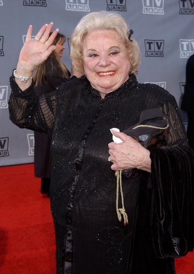 Rose Marie waves at photographers 