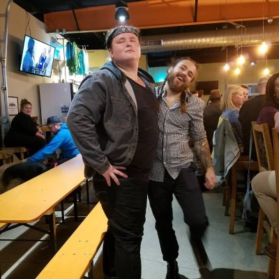 Austin Aynes stands next to Tad Starsiak at a bar