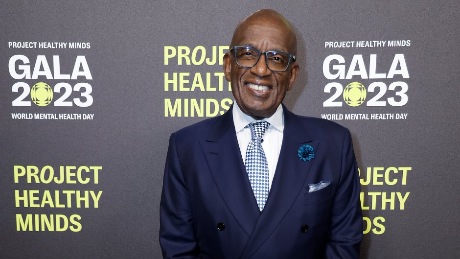 Al Roker stands with his hands crossed while wearing a dark blue suit and a blue tie
