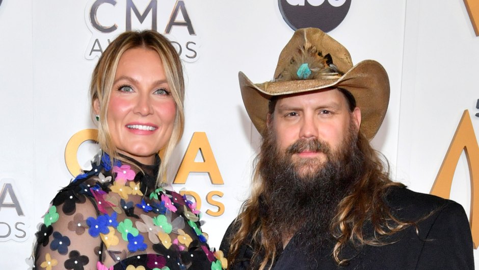 Chris Stapleton in a suit next to wife Morgane in a colorful dress
