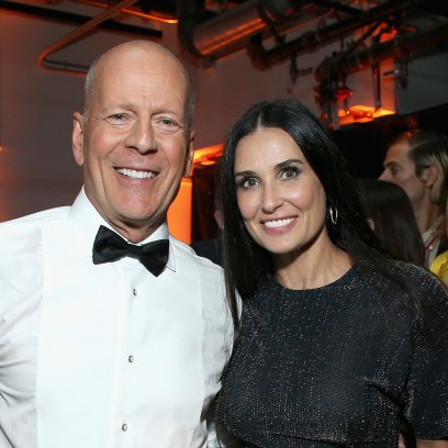 Demi Moore wears a black dress while posing next to ex-husband Bruce Willis