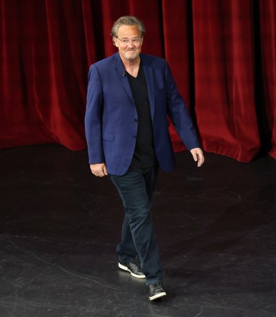 Matthew Perry wears blue blazer and slacks with sneakers